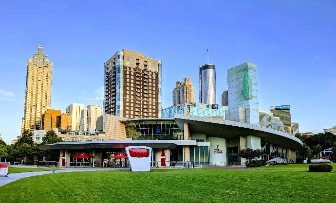 a large building with a green lawn in front of it